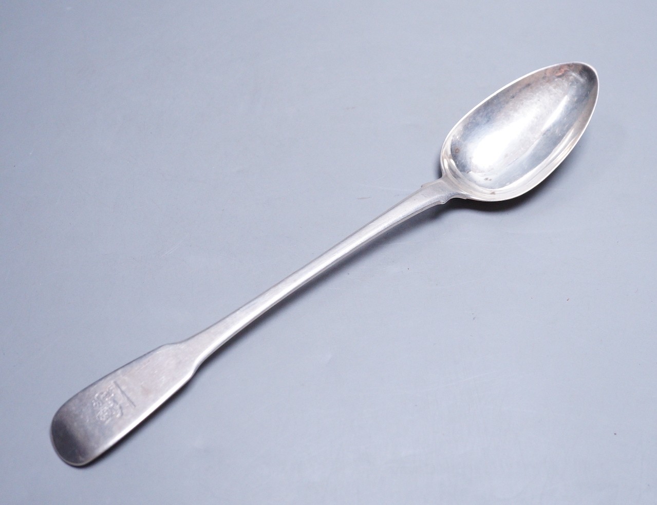 A George III silver fiddle pattern basting spoon, by Eley, Fearn & Chawner, London, 1811, 30.3cm, 124 grams, with engraved crest.